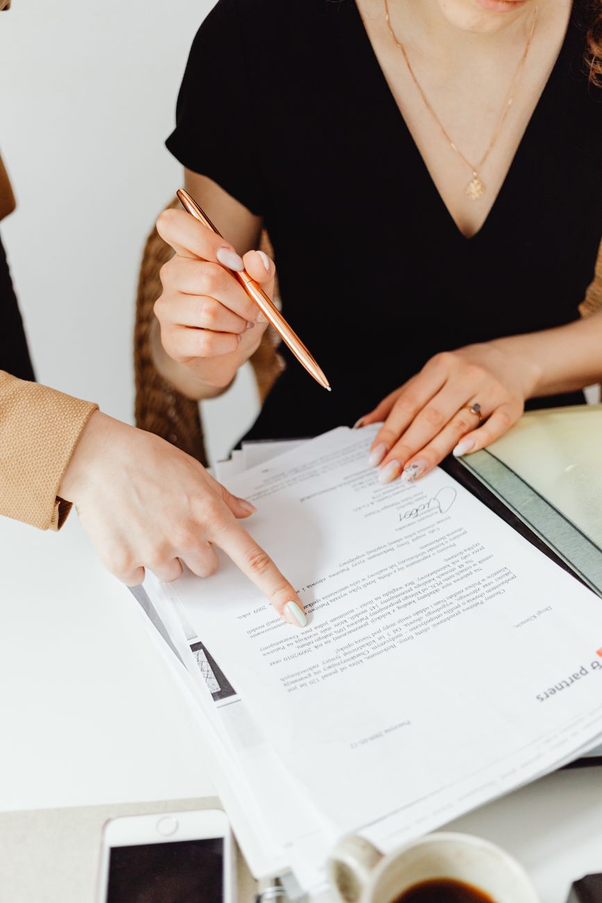 Two people going through a benefits document together at a desk